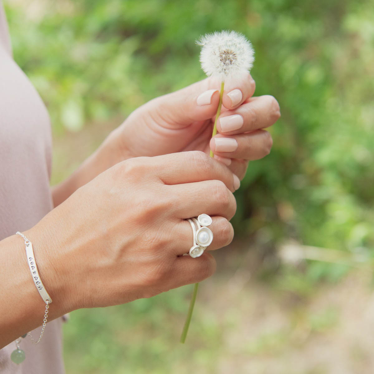 Girl wearing Nesting freshwater large pearl ring hand cast in sterling silver holding inside a large 6mm freshwater pearl 