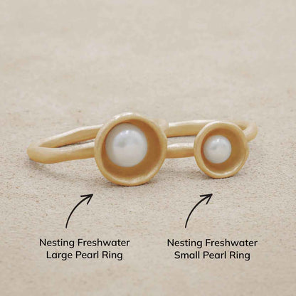 Nesting freshwater large pearl ring hand cast in 10k yellow gold holding inside a large 6mm freshwater pearl 