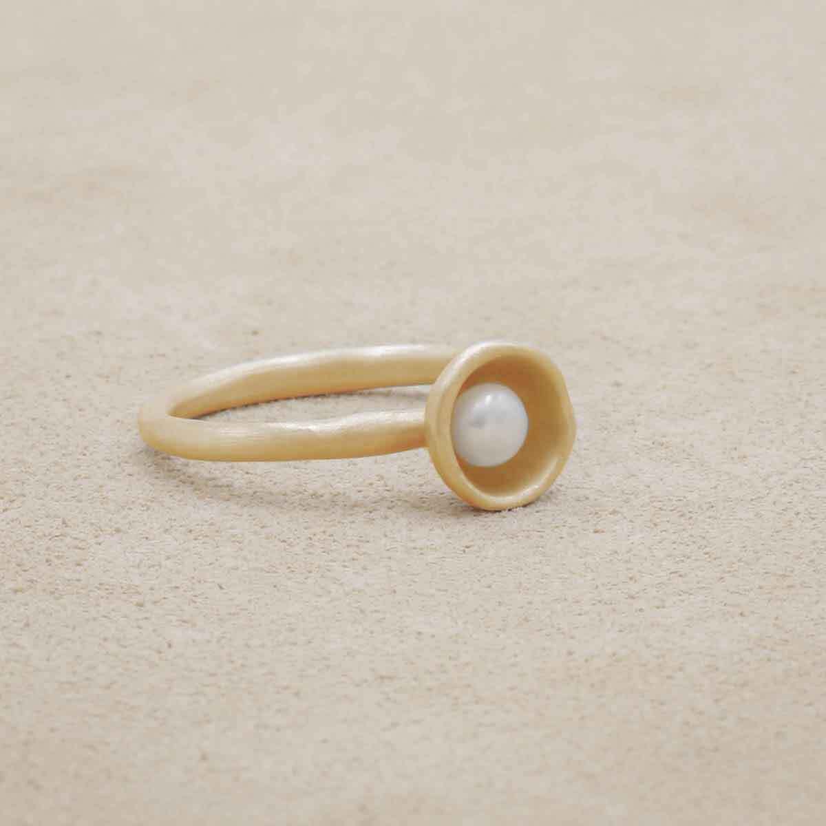 Nesting freshwater small pearl ring hand cast in 10k yellow gold holding inside a small 4mm freshwater pearl