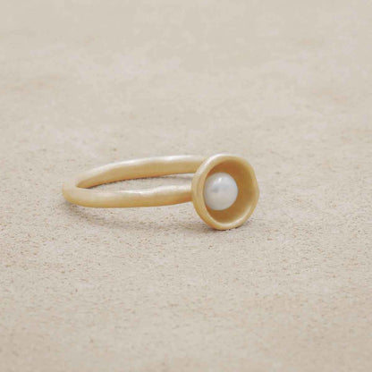 Nesting freshwater small pearl ring hand cast in 10k yellow gold holding inside a small 4mm freshwater pearl