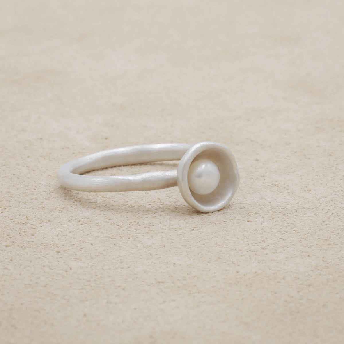 Nesting freshwater small pearl ring hand cast in sterling silver holding inside a small 4mm freshwater pearl