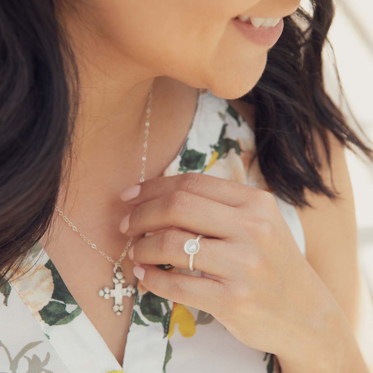 Girl wearing her Nesting freshwater small pearl ring hand cast in sterling silver holding inside a small 4mm freshwater pearl