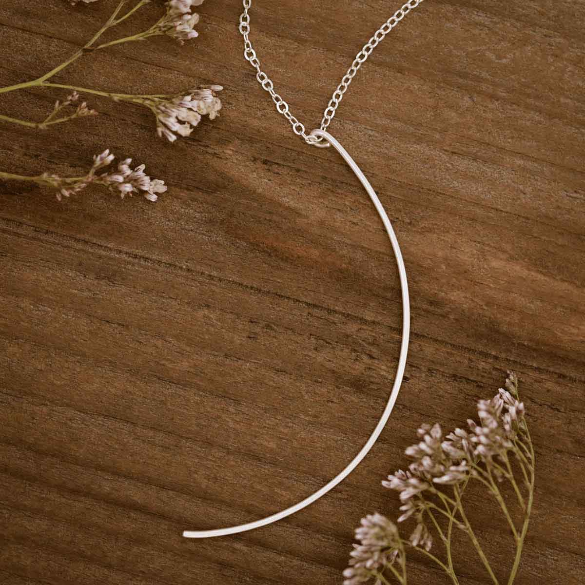 Woman wearing a sterling silver New Moon Necklace