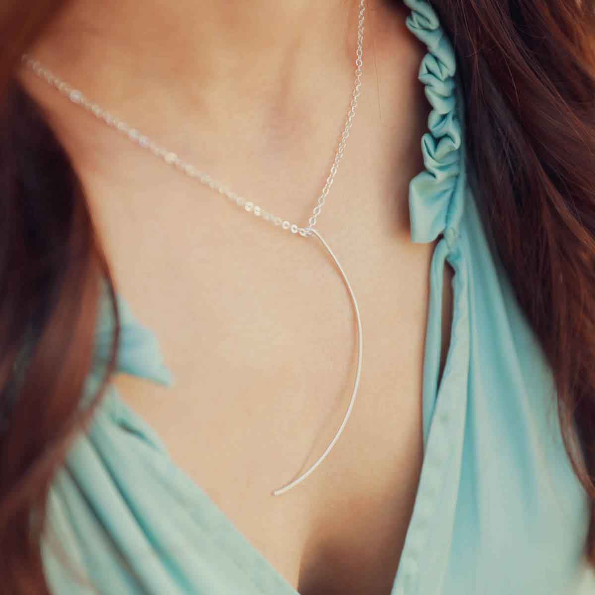 Woman wearing a sterling silver New Moon Necklace