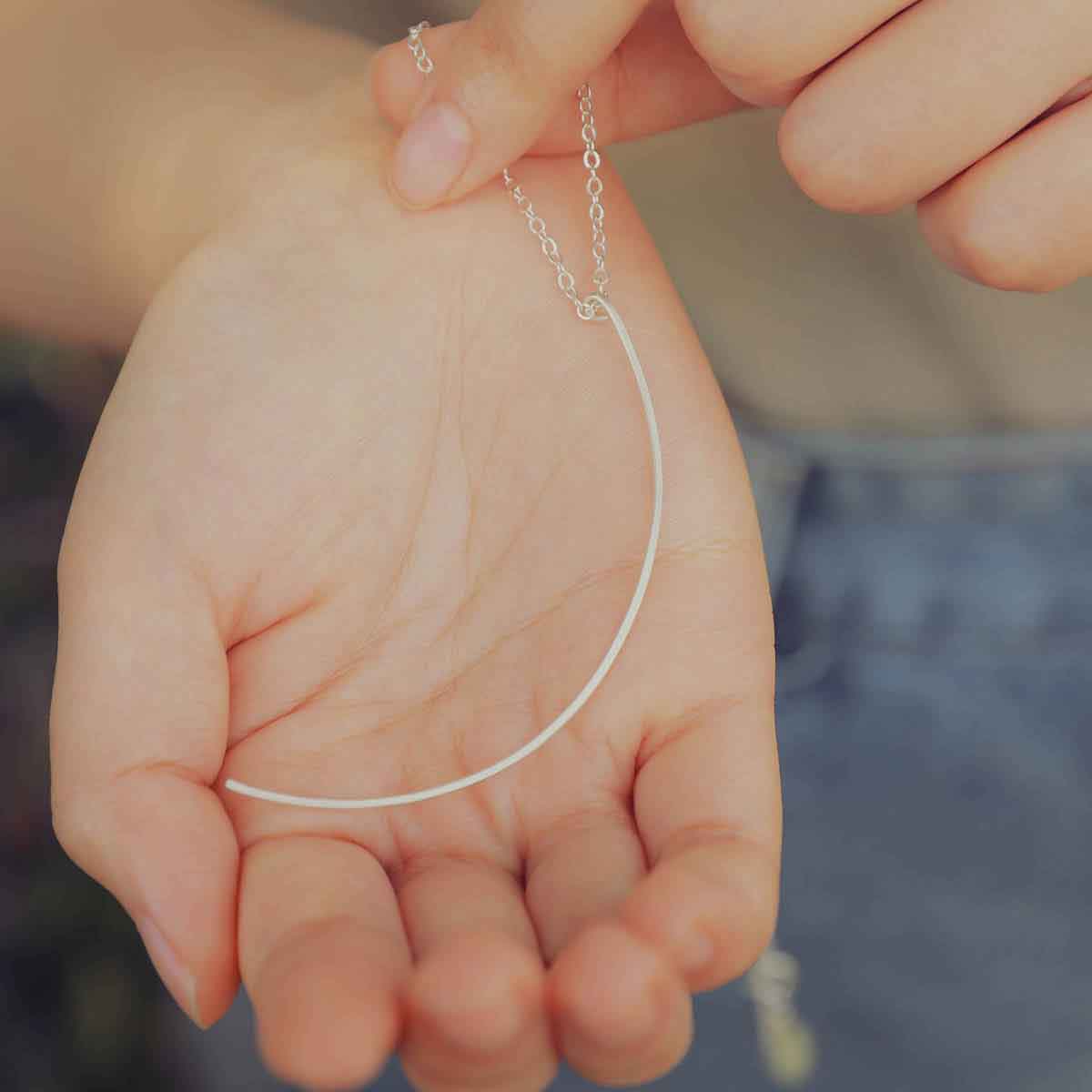 Woman wearing a sterling silver New Moon Necklace