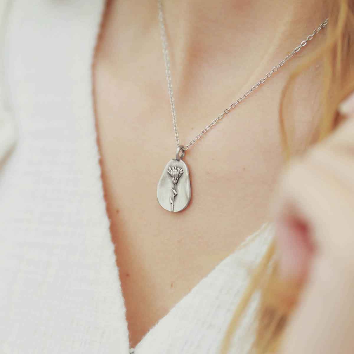 girl wearing a sterling silver October birth flower necklace