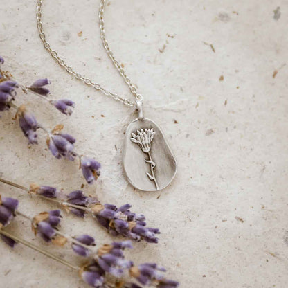 girl wearing a pewter October Birth Flower necklace with 18" link chain