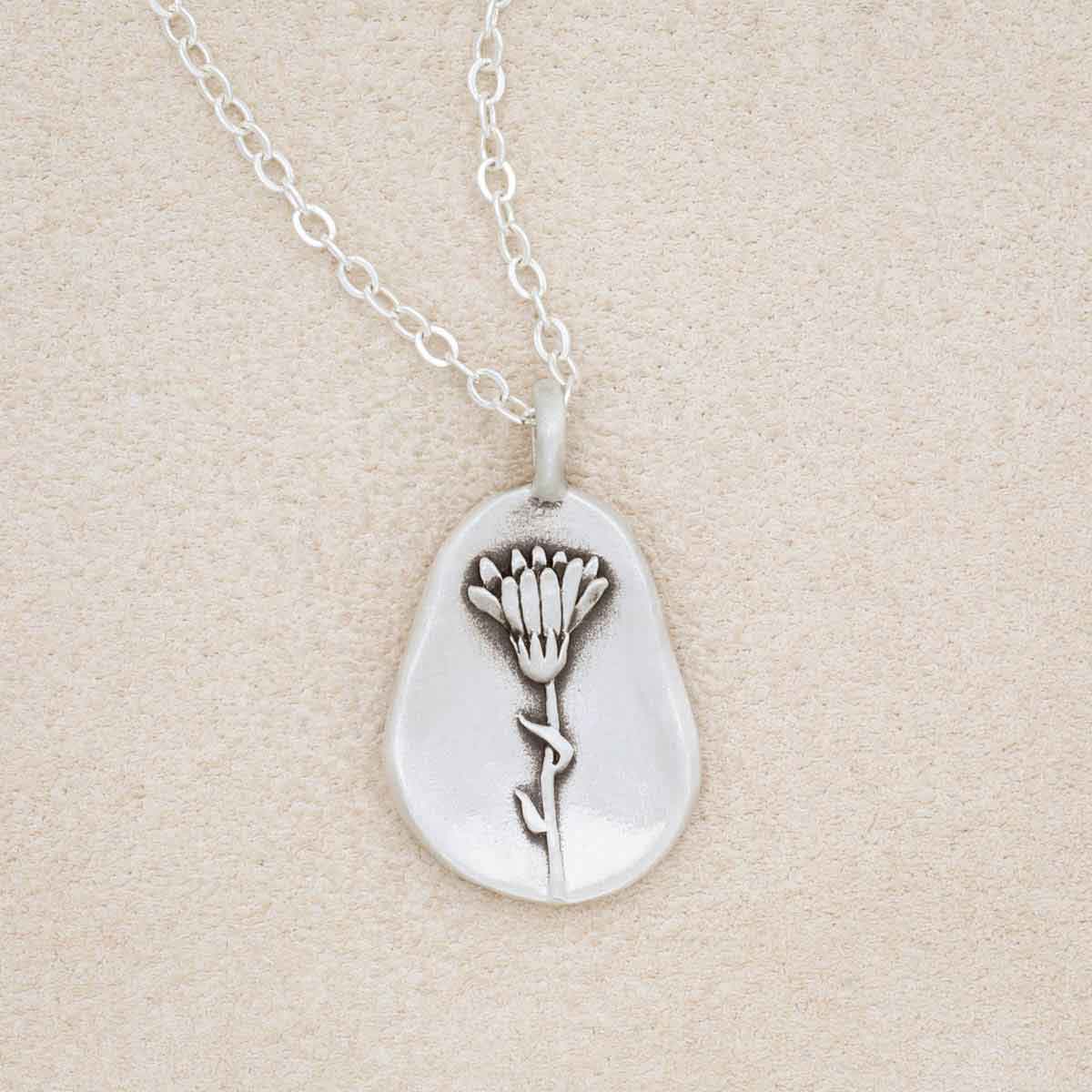 sterling silver October birth flower necklace, on beige background