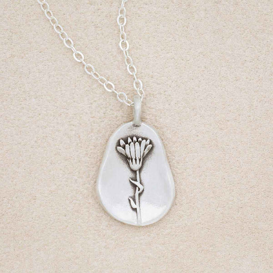 sterling silver October birth flower necklace, on beige background