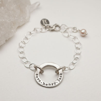 Sterling silver open circle pearl bracelet with a dangling freshwater pearl