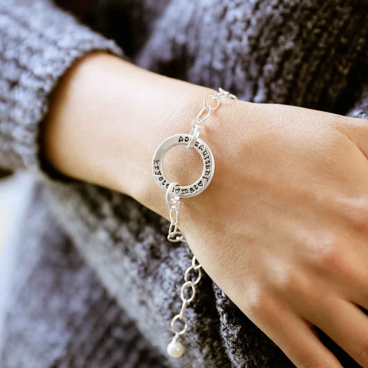 girl wearing personalized sterling silver open circle pearl bracelet on her wrist