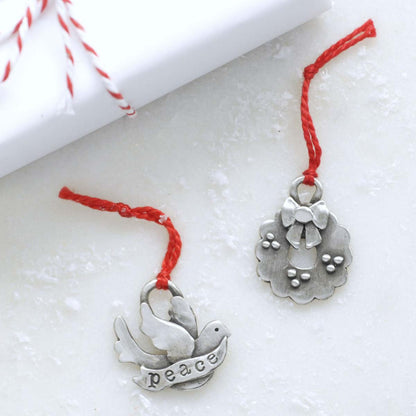 our Christmas tradition advent ornament set handcrafted and cast in fine pewter with 2 of the 24 on display