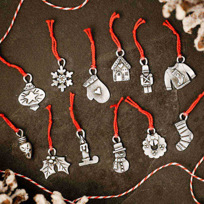 our Christmas tradition advent ornament set handcrafted and cast in fine pewter and includes all 24 ornaments in individual numbered bags