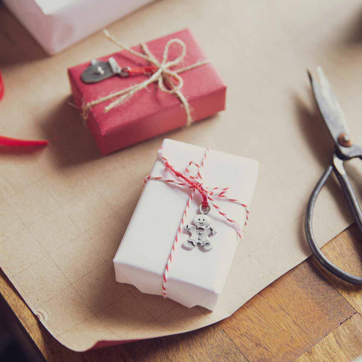 our Christmas tradition advent ornament set handcrafted and cast in fine pewter with 2 of the 24 on tied around Christmas presents