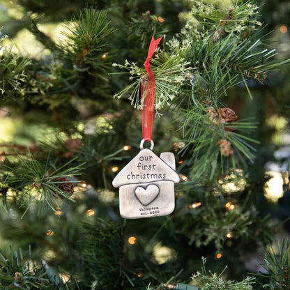 our first Christmas ornament hand-molded and cast in fine pewter and personalized with up to 2 lines of a meaningful message hung on a Christmas tree