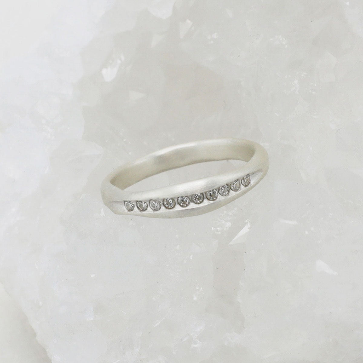 Passage ring handcrafted in sterling silver and display of 1.5mm cubic zirconias 