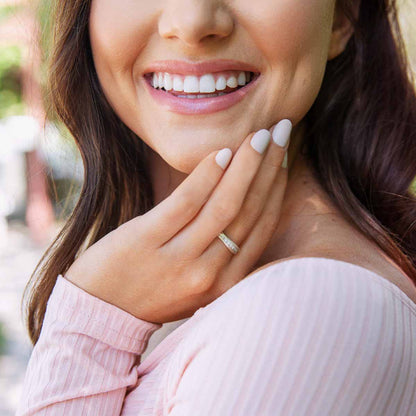 Girl wearing Passage ring handcrafted in sterling silver and display of 1.5mm cubic zirconias 