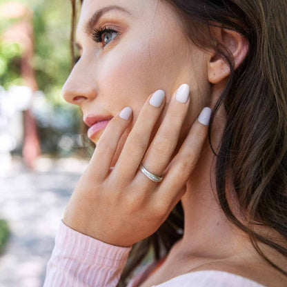 Girl wearing Passage ring handcrafted in sterling silver and display of 1.5mm cubic zirconias 