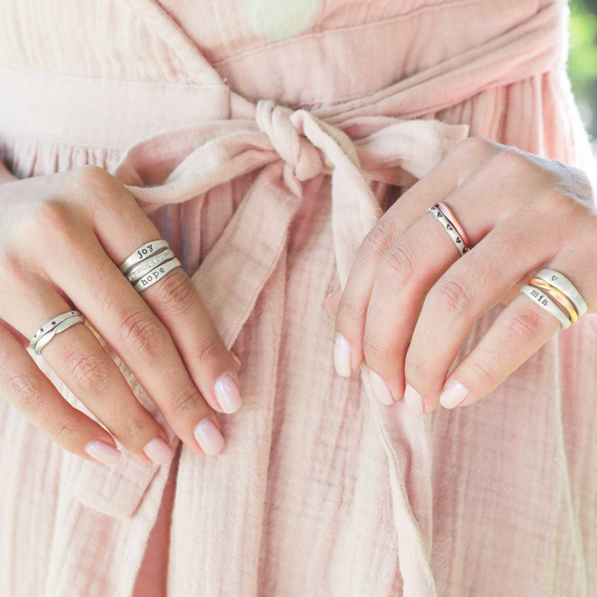 Girl wearing Passage ring handcrafted in sterling silver and display of 1.5mm cubic zirconias 