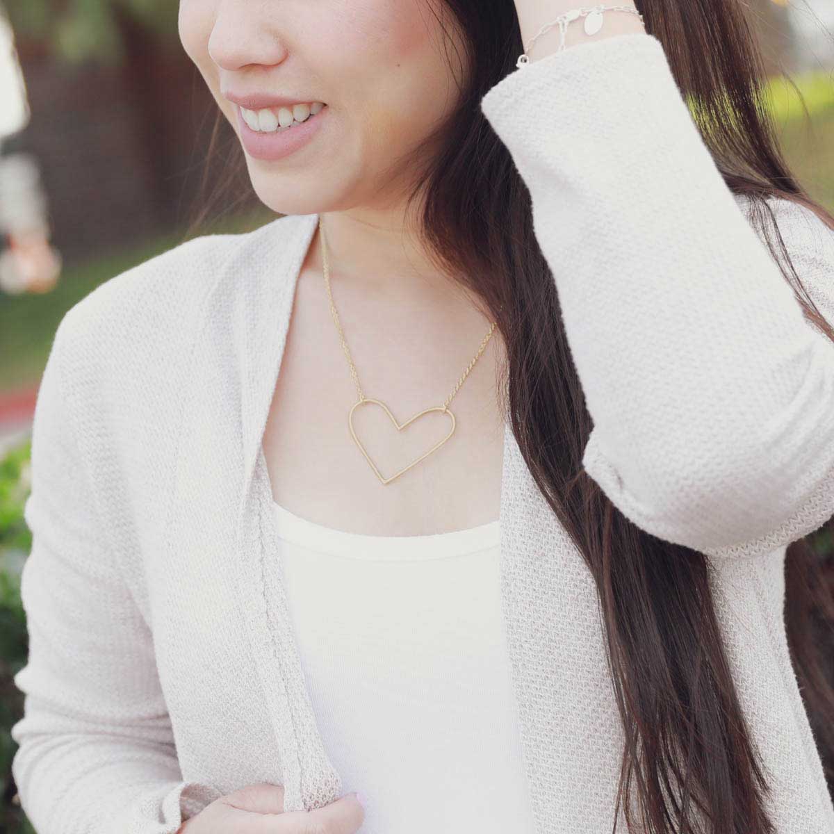 girl wearing a gold filled Peaceful Heart Necklace