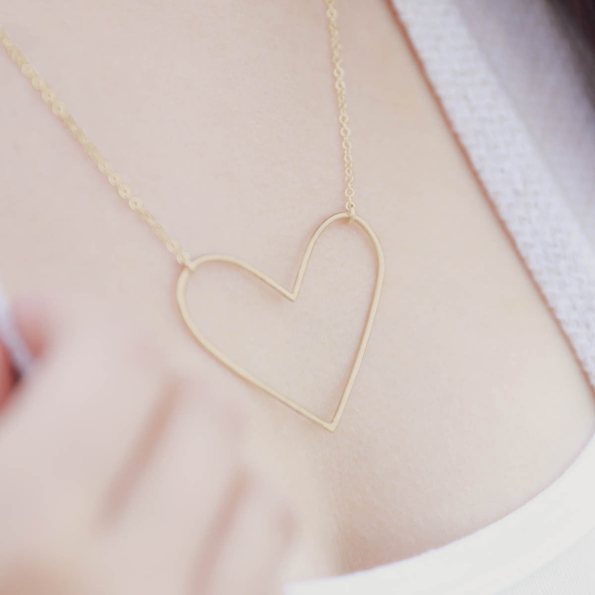 girl wearing a gold filled Peaceful Heart Necklace