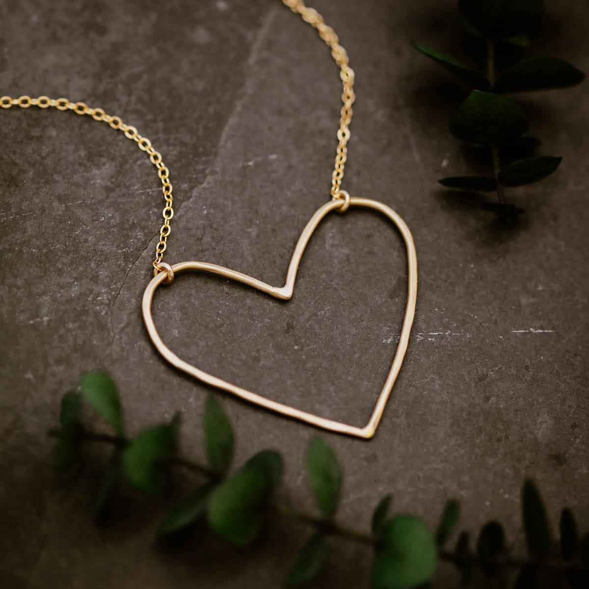 Gold filled Peaceful Heart Necklace on slate background