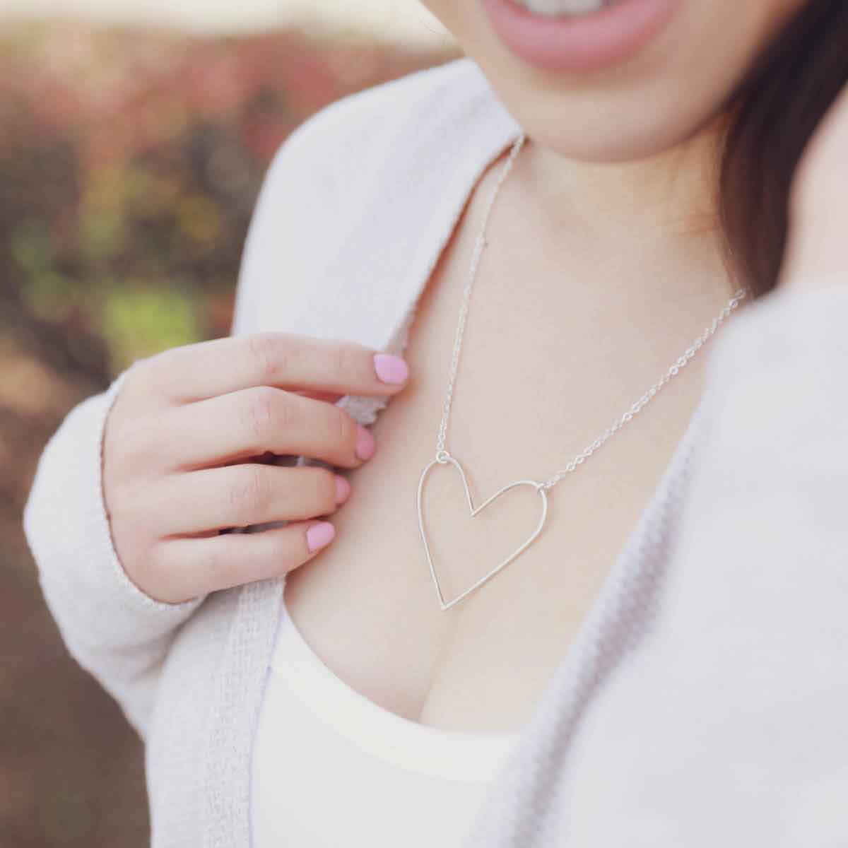 girl wearing a Peaceful Heart Necklace handcrafted in sterling silver