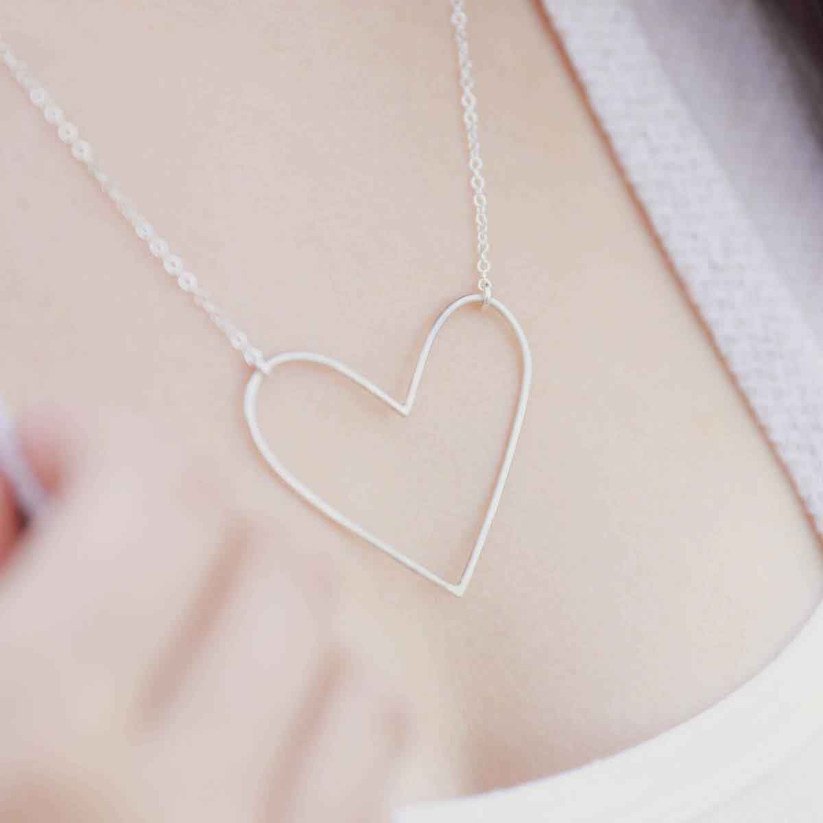 girl wearing a Peaceful Heart Necklace handcrafted in sterling silver