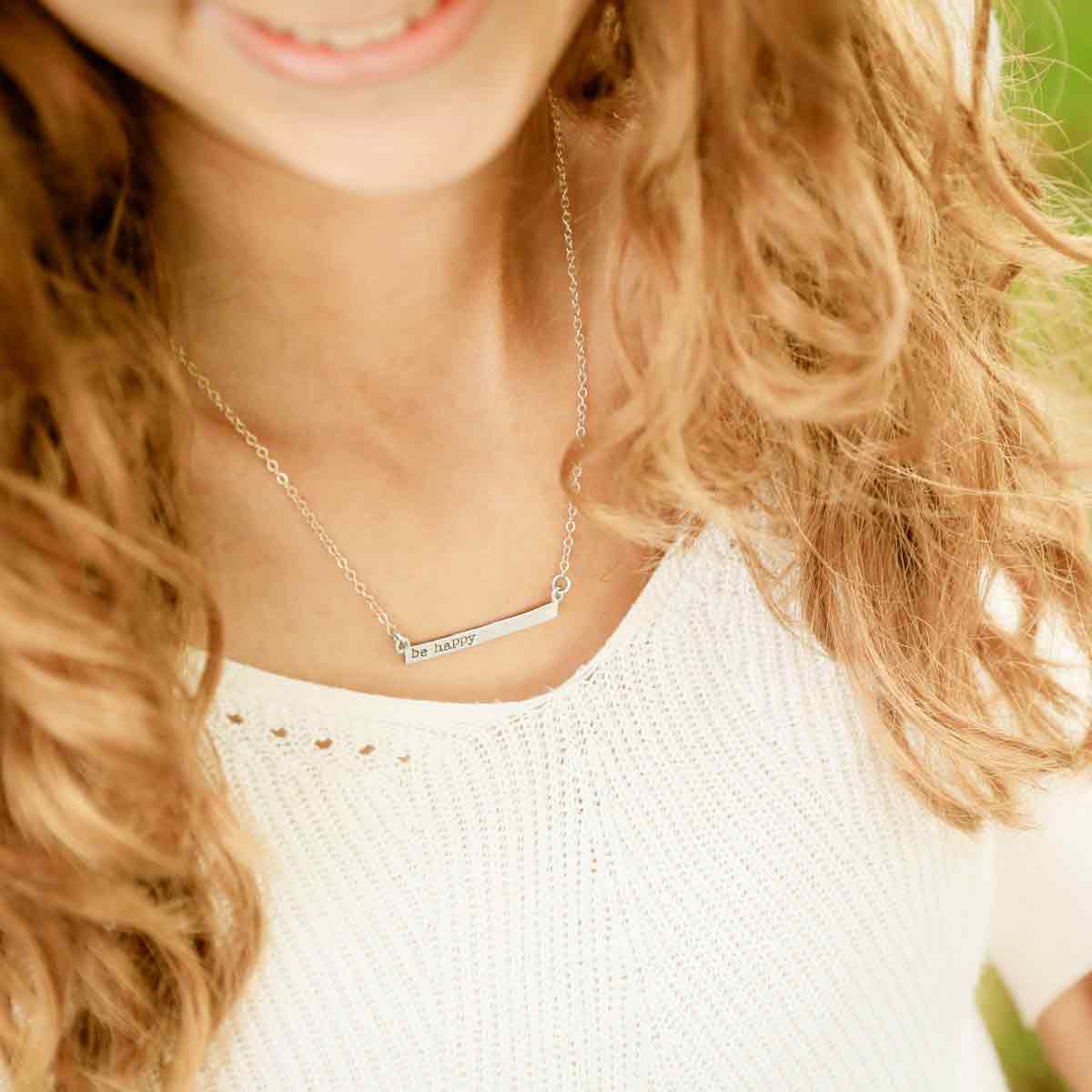 girl wearing sterling silver personalized cross bar necklace 