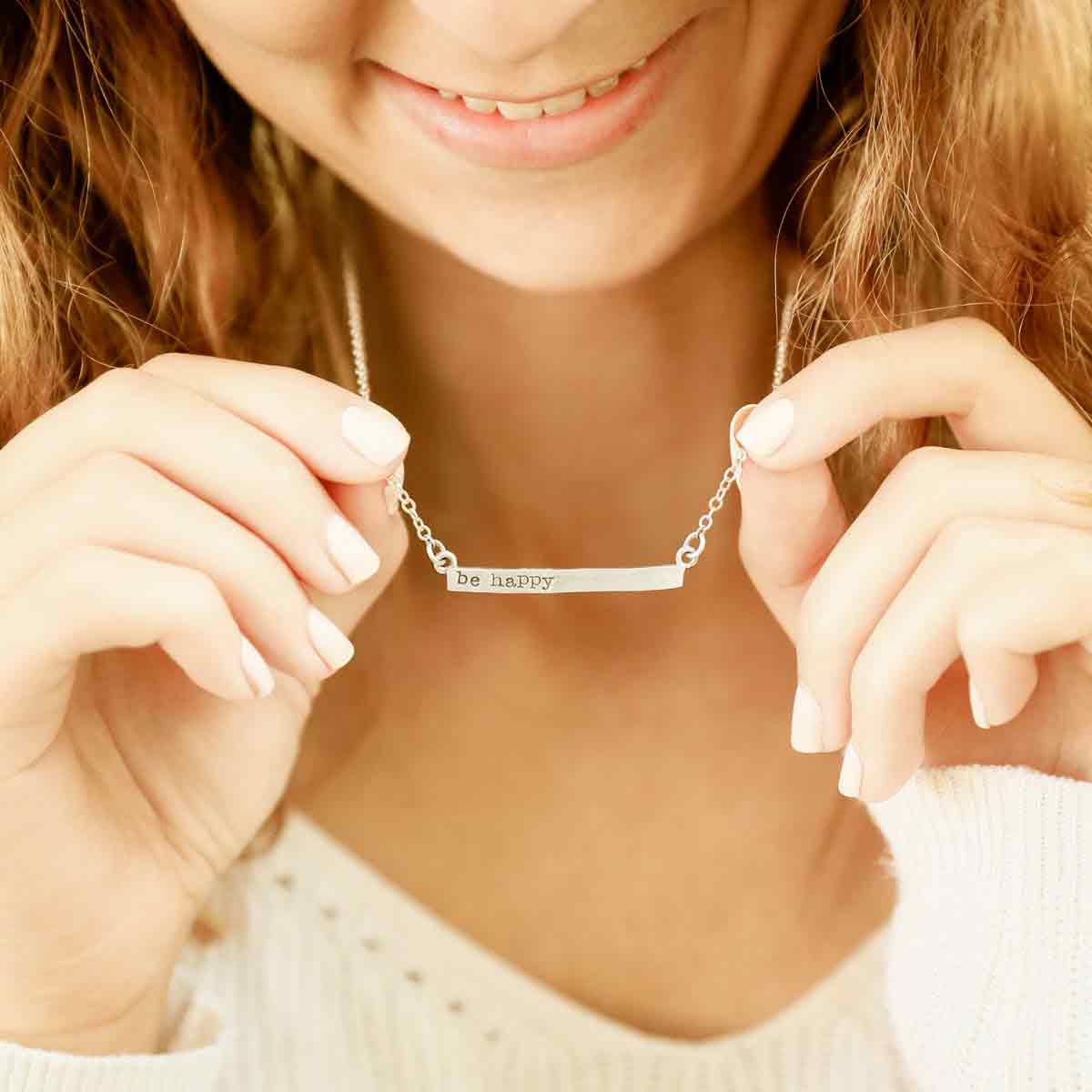 girl wearing sterling silver personalized cross bar necklace 