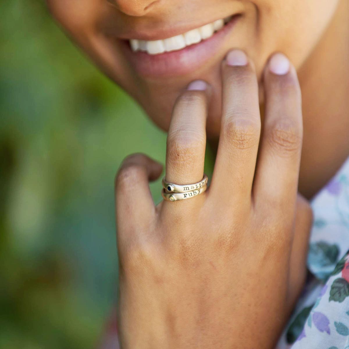 Girl wearing Personalized passage ring handcrafted in 10k yellow gold with your choice of birthstone 