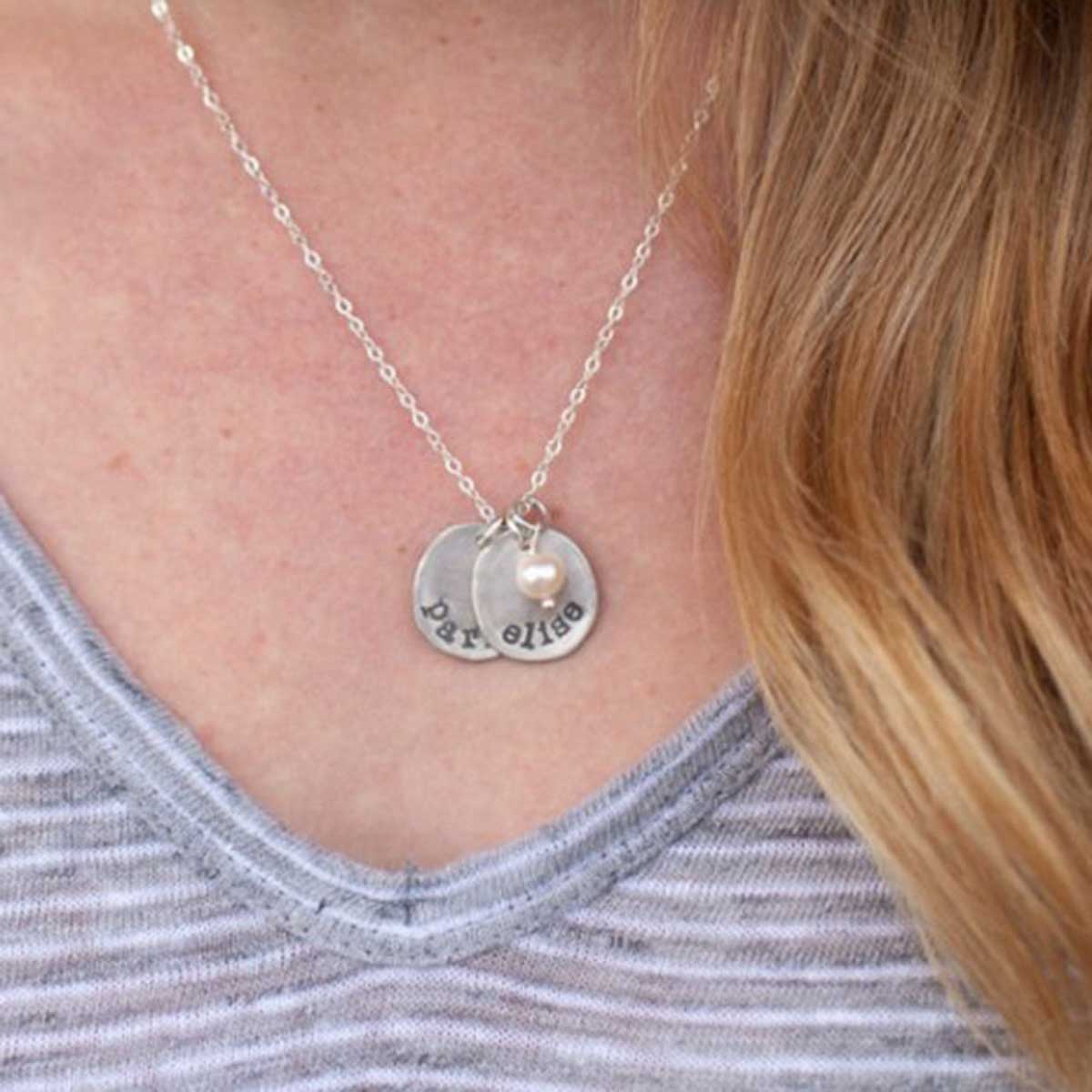 mom wearing sterling silver petite mother's necklace with personalized charms and freshwater pearl