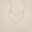 A gold filled Petite Peaceful Heart Necklace on beige background