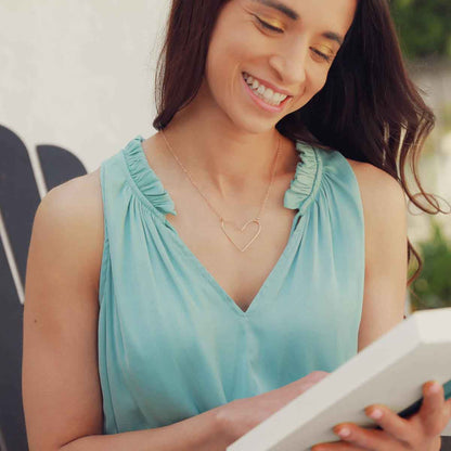 Woman wearing a gold filled Petite Peaceful Heart Necklace