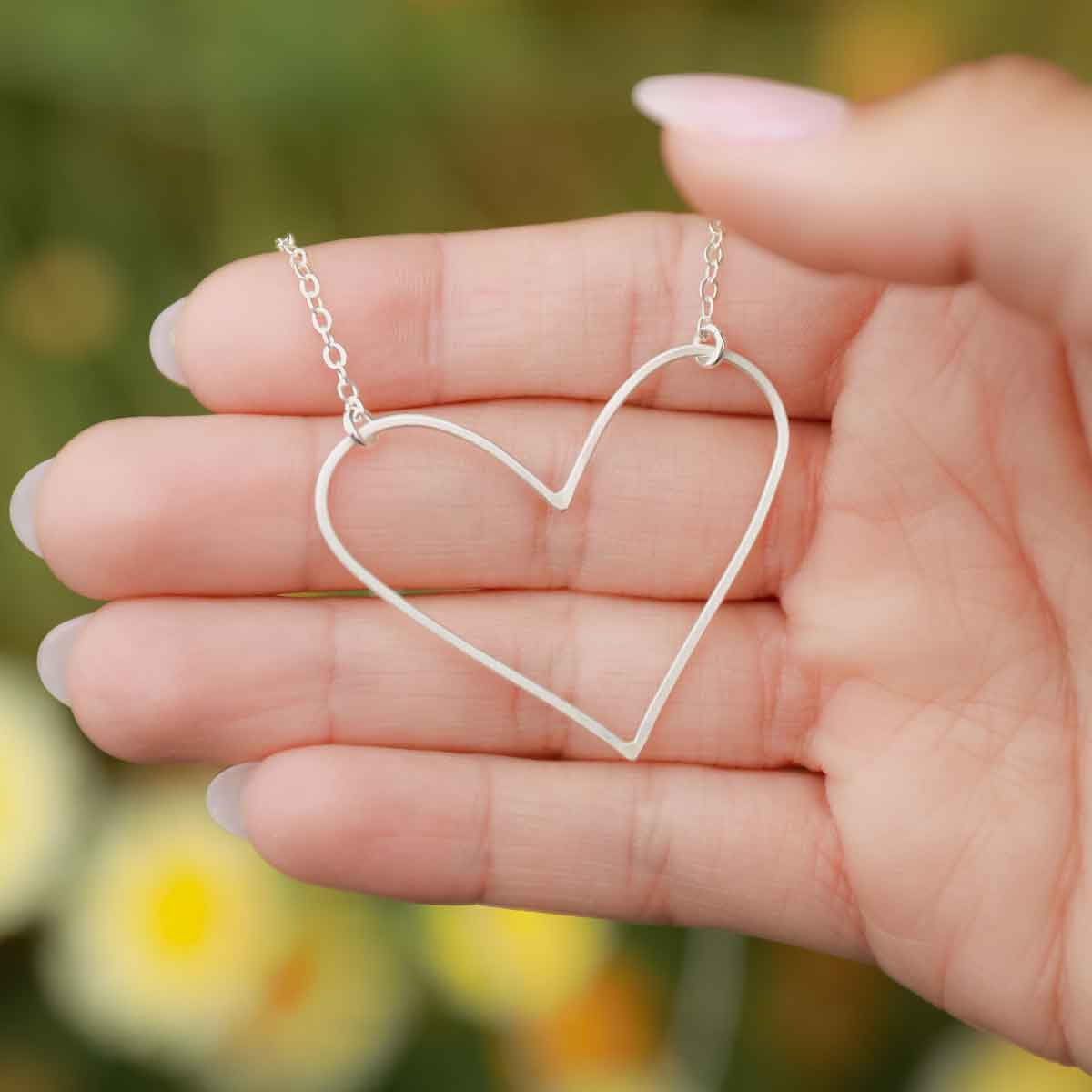 Girl wearing a sterling silver Petite Peaceful Heart Necklace