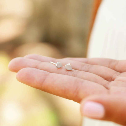 hand holding sterling silver raindrop stud earrings