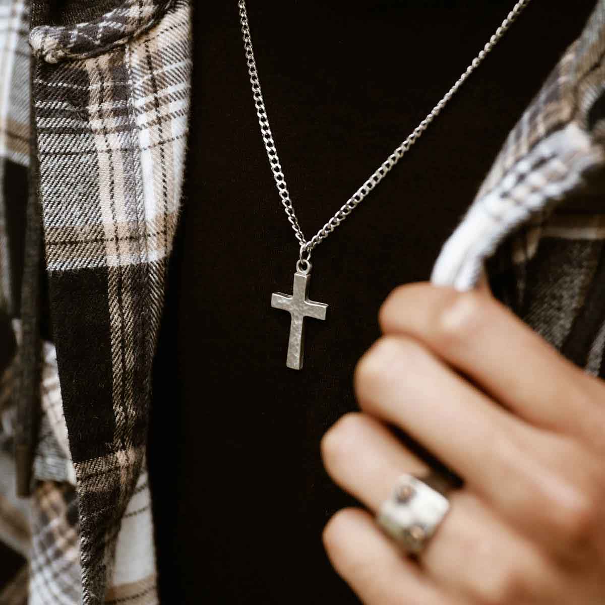 man wearing a pewter Redemption Cross Necklace