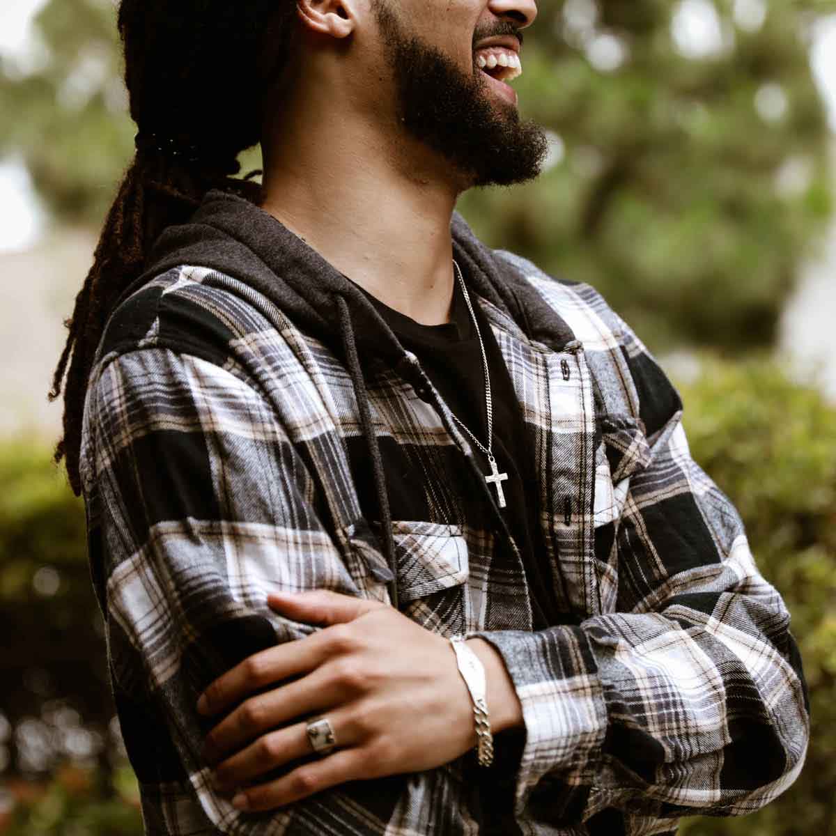 man wearing a pewter Redemption Cross Necklace