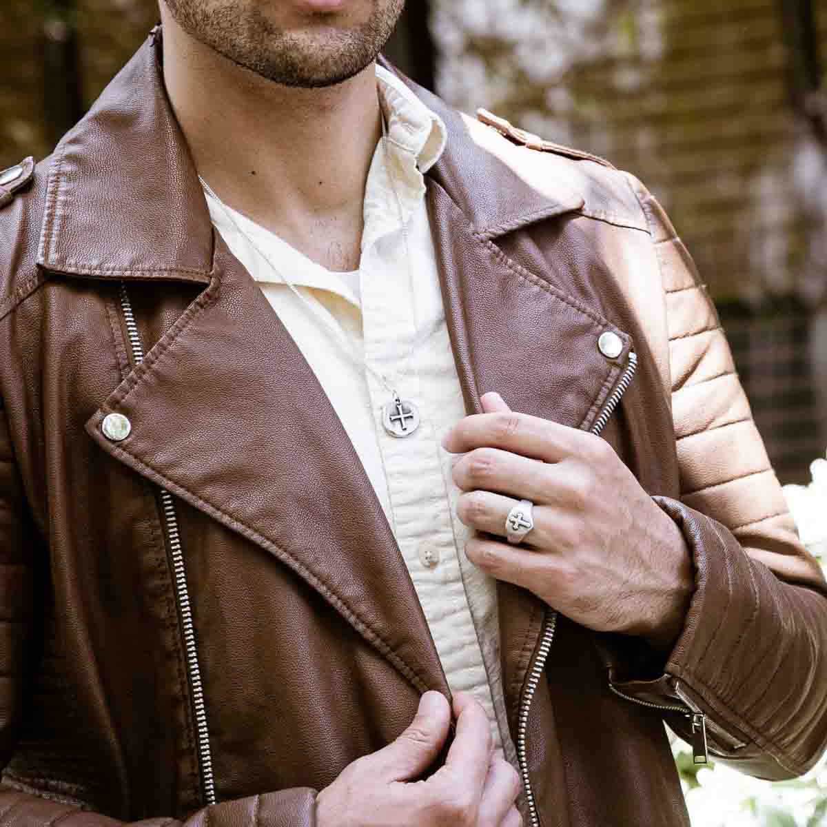 Man wearing Roman Cross Coin necklace handcrafted in sterling silver strung on sterling silver curb chain 