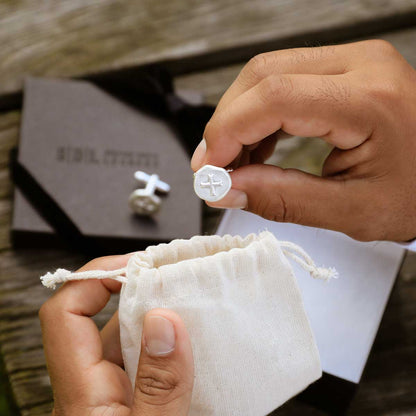 Wedding groom unboxing his roman cross cufflinks handcrafted in sterling silver