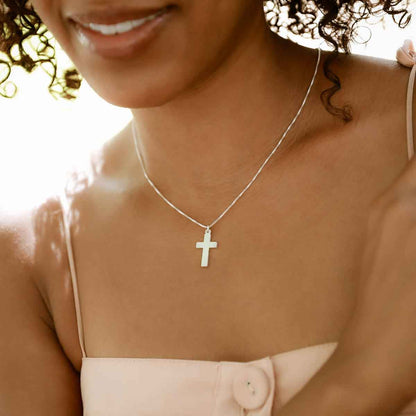 woman wearing a sterling silver Rooted and Grounded Cross necklace