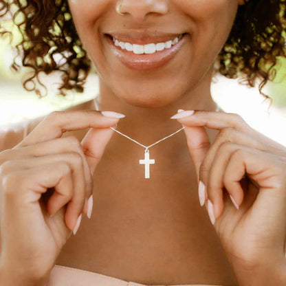 woman wearing a sterling silver Rooted and Grounded Cross necklace