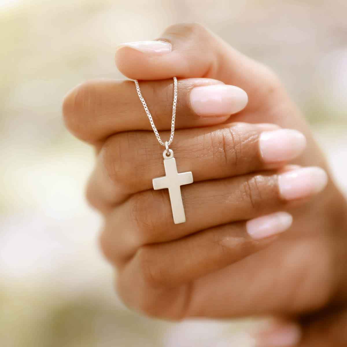 woman wearing a sterling silver Rooted and Grounded Cross necklace