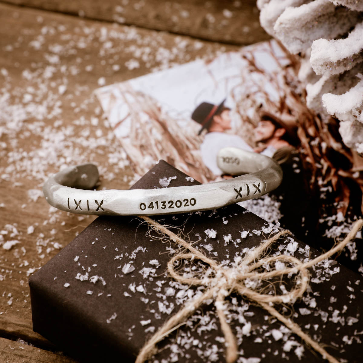 Man with his daughter while wearing Forge a path men's cuff bracelet hand-carved in fine pewter personalized with a name