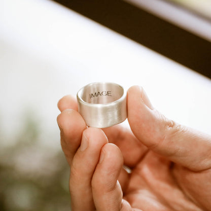 Man wearing Valor Wide ring handcrafted in sterling silver customizable with a meaningful name