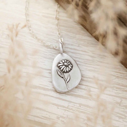 girl wearing a sterling silver September birth flower necklace