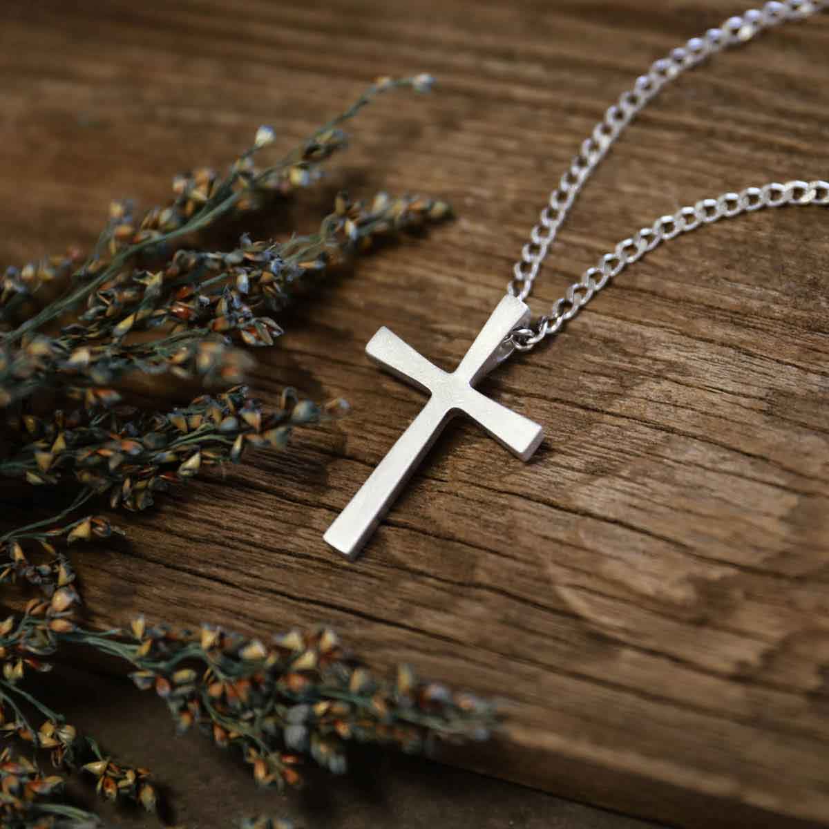 man wearing a pewter Set Free Cross Necklace