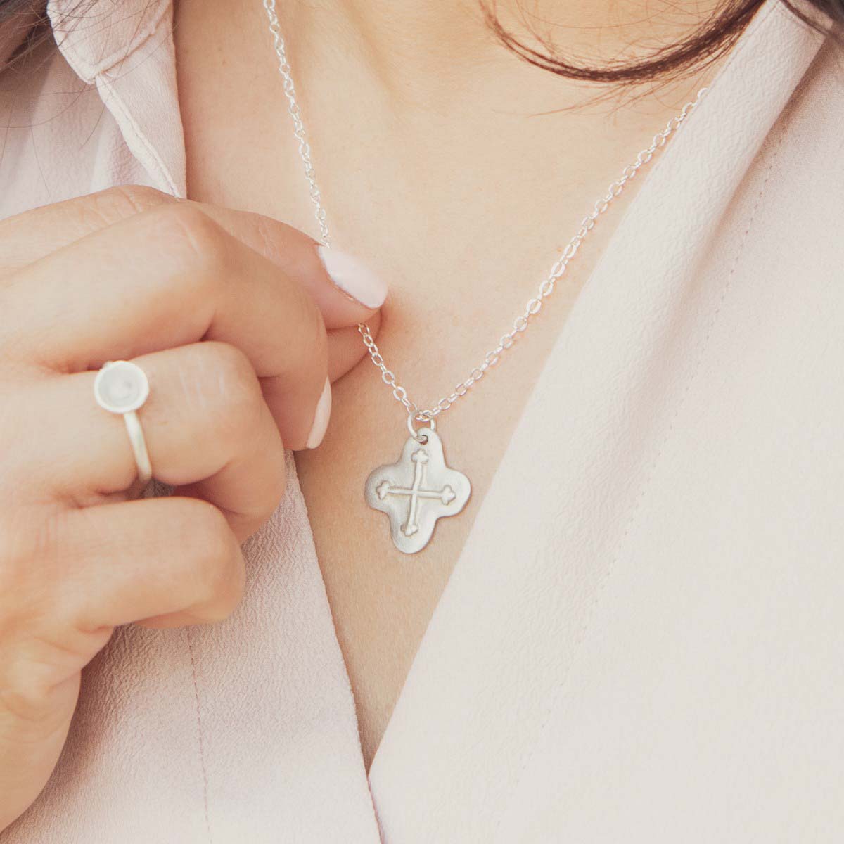 woman wearing sterling silver shining light cross necklace