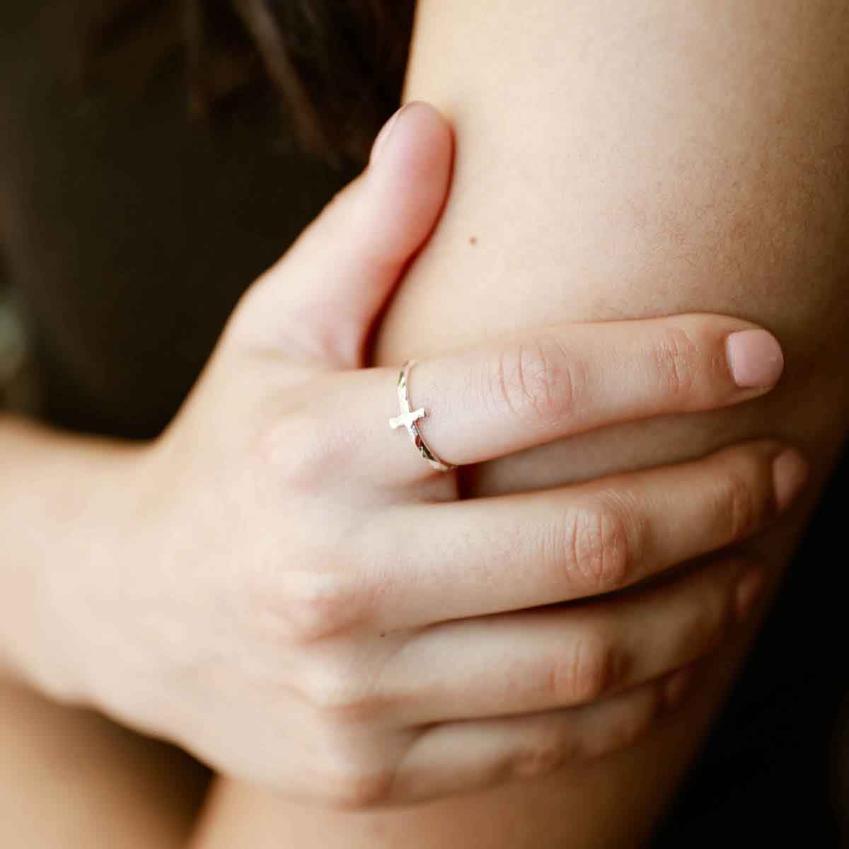 woman wearing a sterling silver Simple Hammered Cross Ring