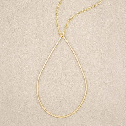 Sorrow and Joy Teardrop Necklace handcrafted in gold filled, on suede background 
